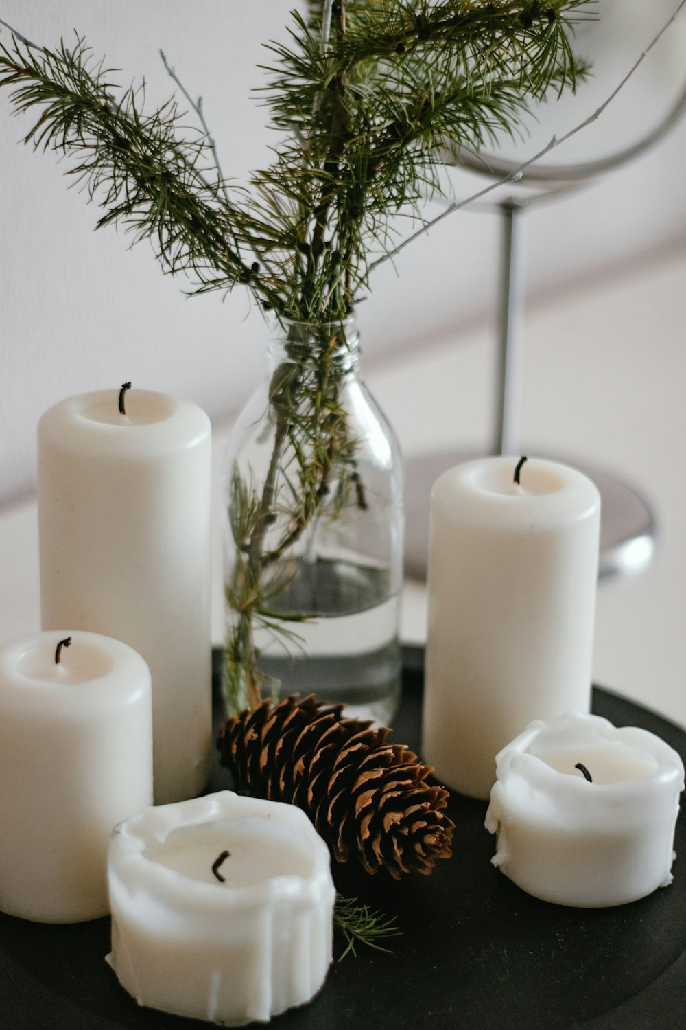 white pillar candles on clear glass candle holder