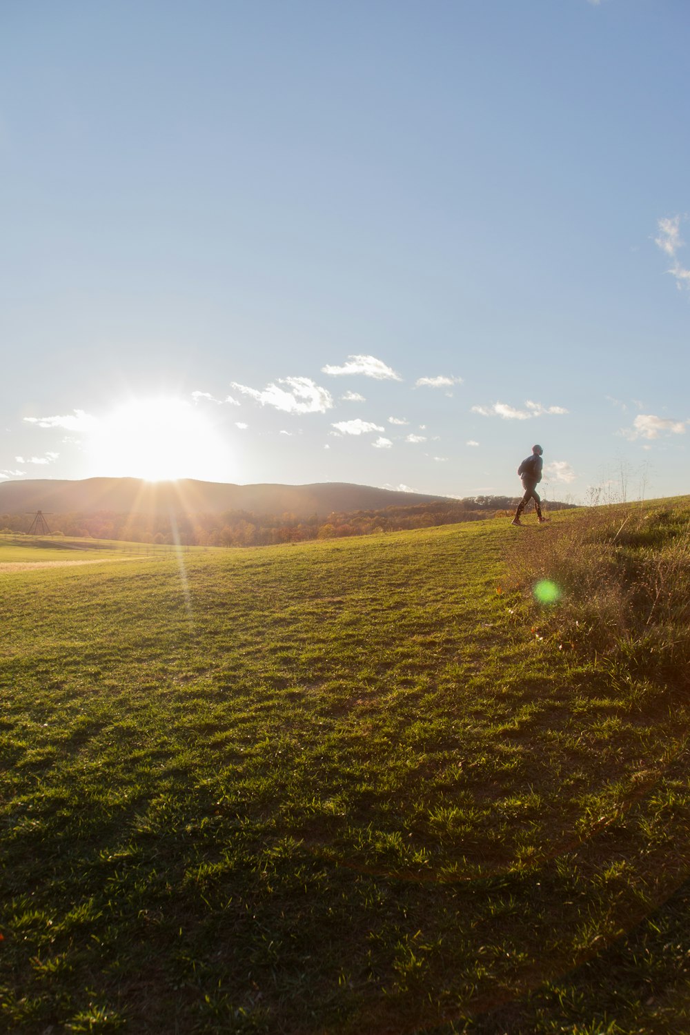 man in black shirt and pants standing on green grass field during daytime