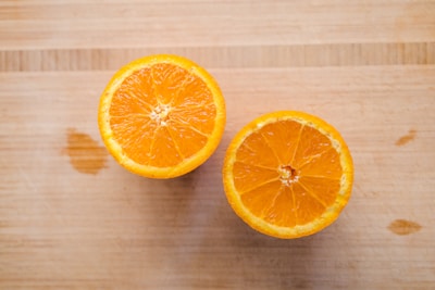 sliced orange fruit on brown wooden table