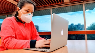 A friendly person typing on a laptop with Tamaulipas cityscape in the background