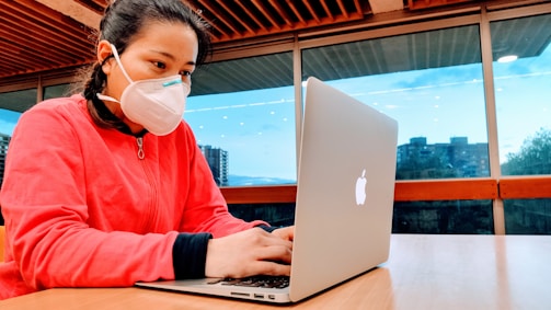 A friendly person typing on a laptop with Tamaulipas cityscape in the background