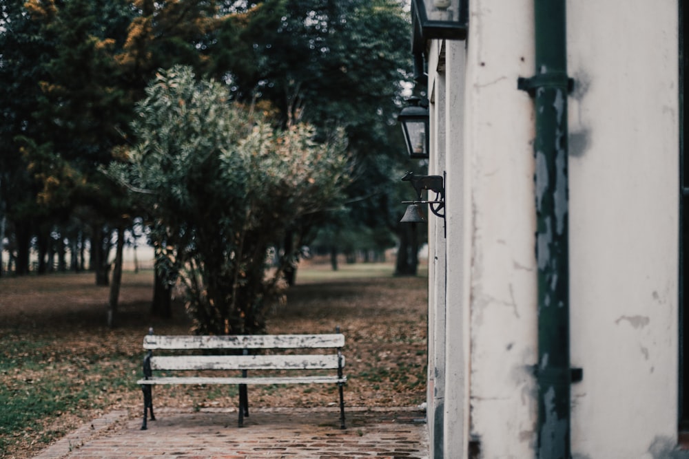 black metal bench beside white wall