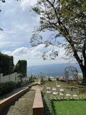 Scenic outdoor setup for a private event surrounded by forest and mountain views.