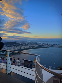 A stunning panoramic view of the sea from a spacious Empire Tower balcony during sunset.