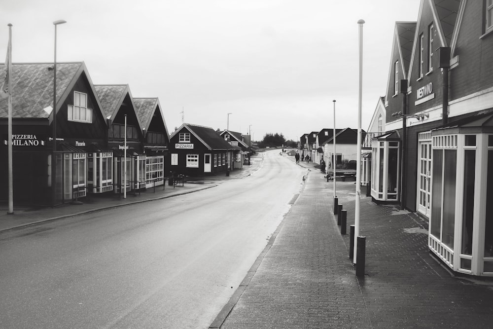 grayscale photo of houses near road
