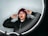 man in black jacket and red knit cap sitting on chair