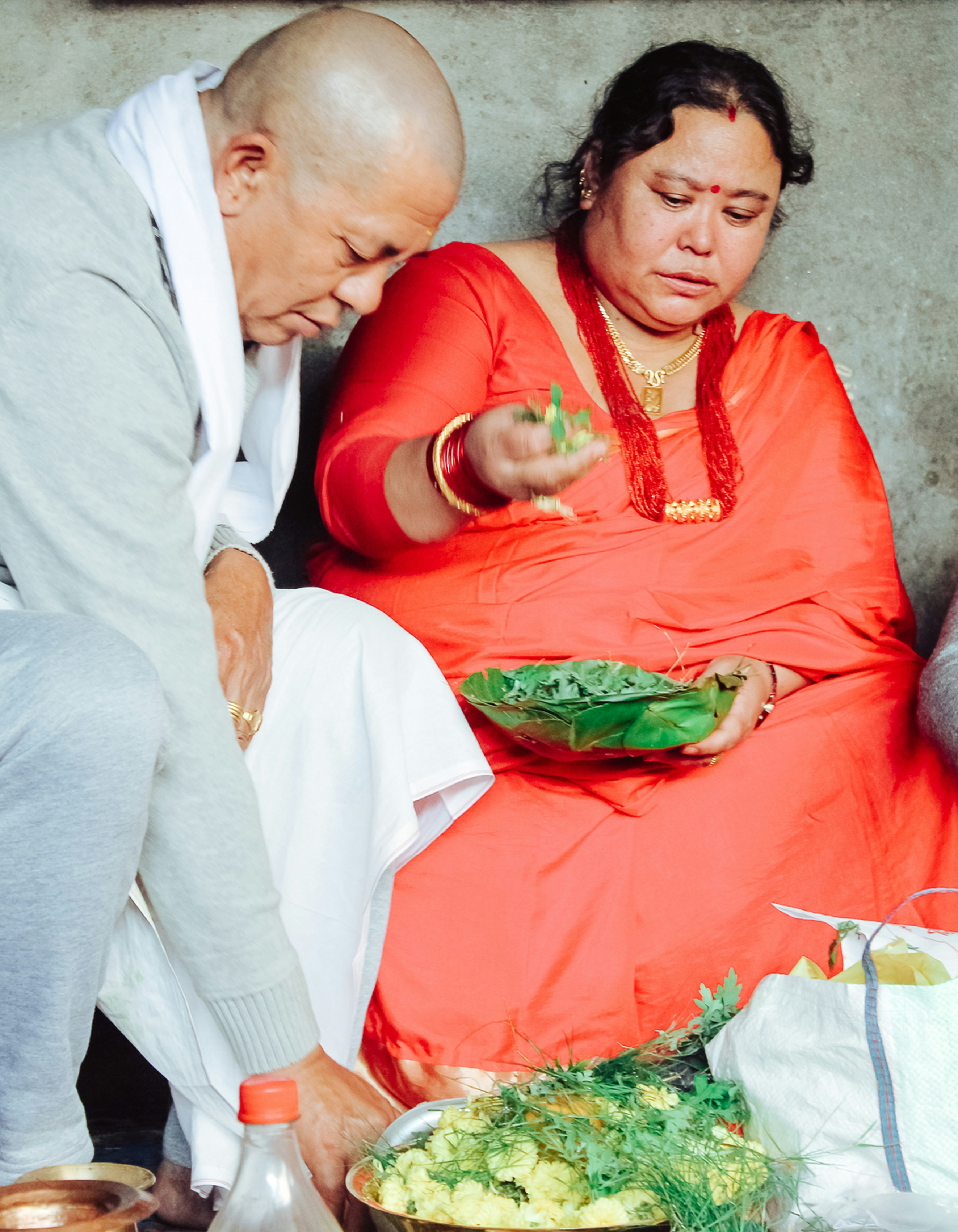 man in white thobe sitting beside woman in green dress