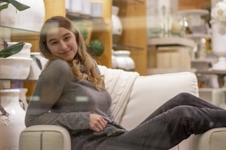 A friendly customer service representative answering a phone call in a cozy furniture shop.