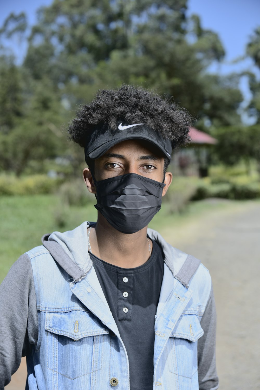 man in gray zip up jacket wearing black face mask