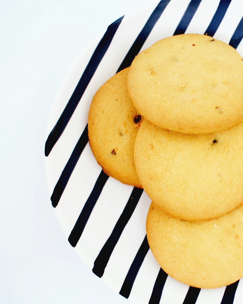 brown cookies on white and black striped plate