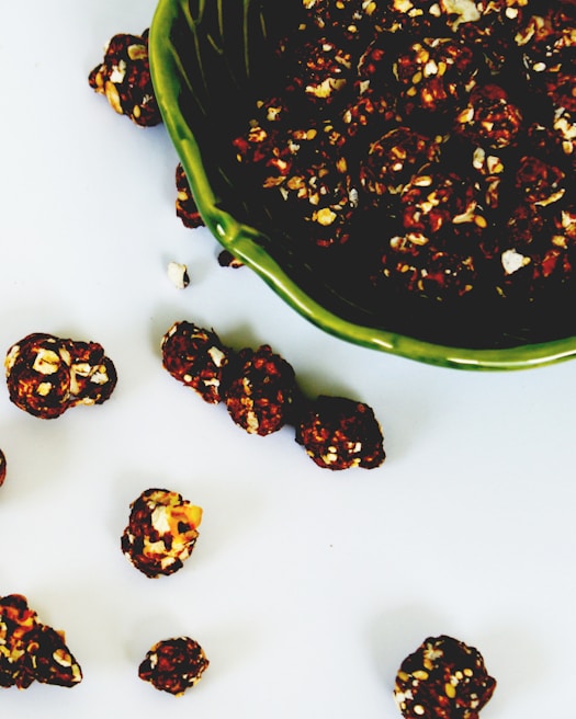 A vibrant spread of ethico eat's caramel popcorn in eco-friendly packaging on a wooden table