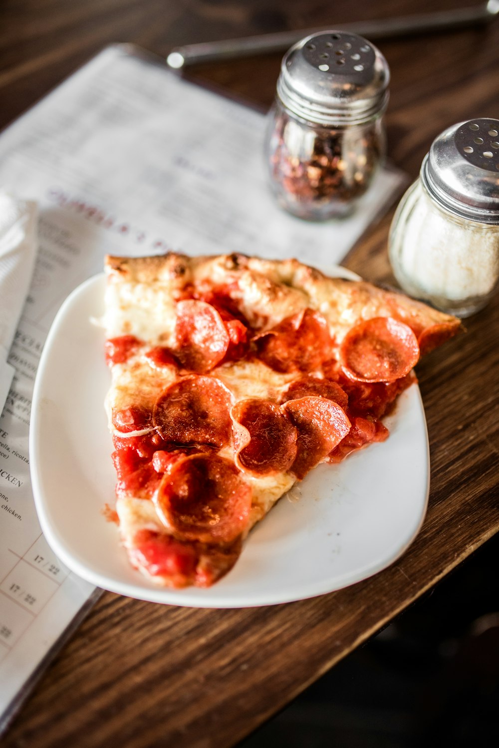 sliced pizza on white ceramic plate