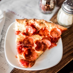 sliced pizza on white ceramic plate