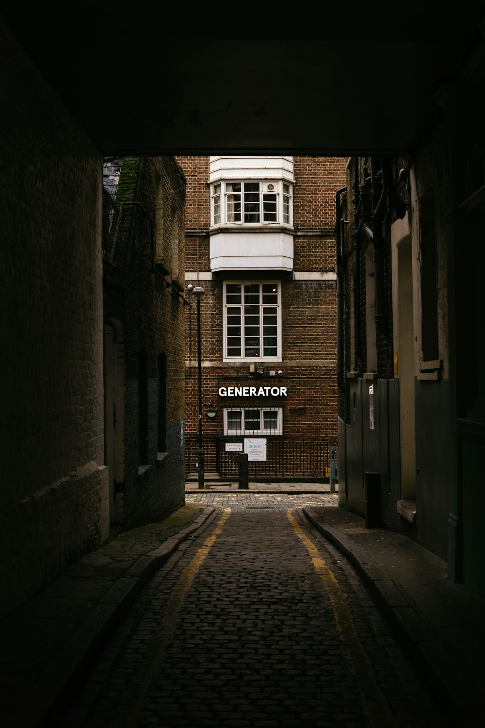 brown brick building with black metal gate