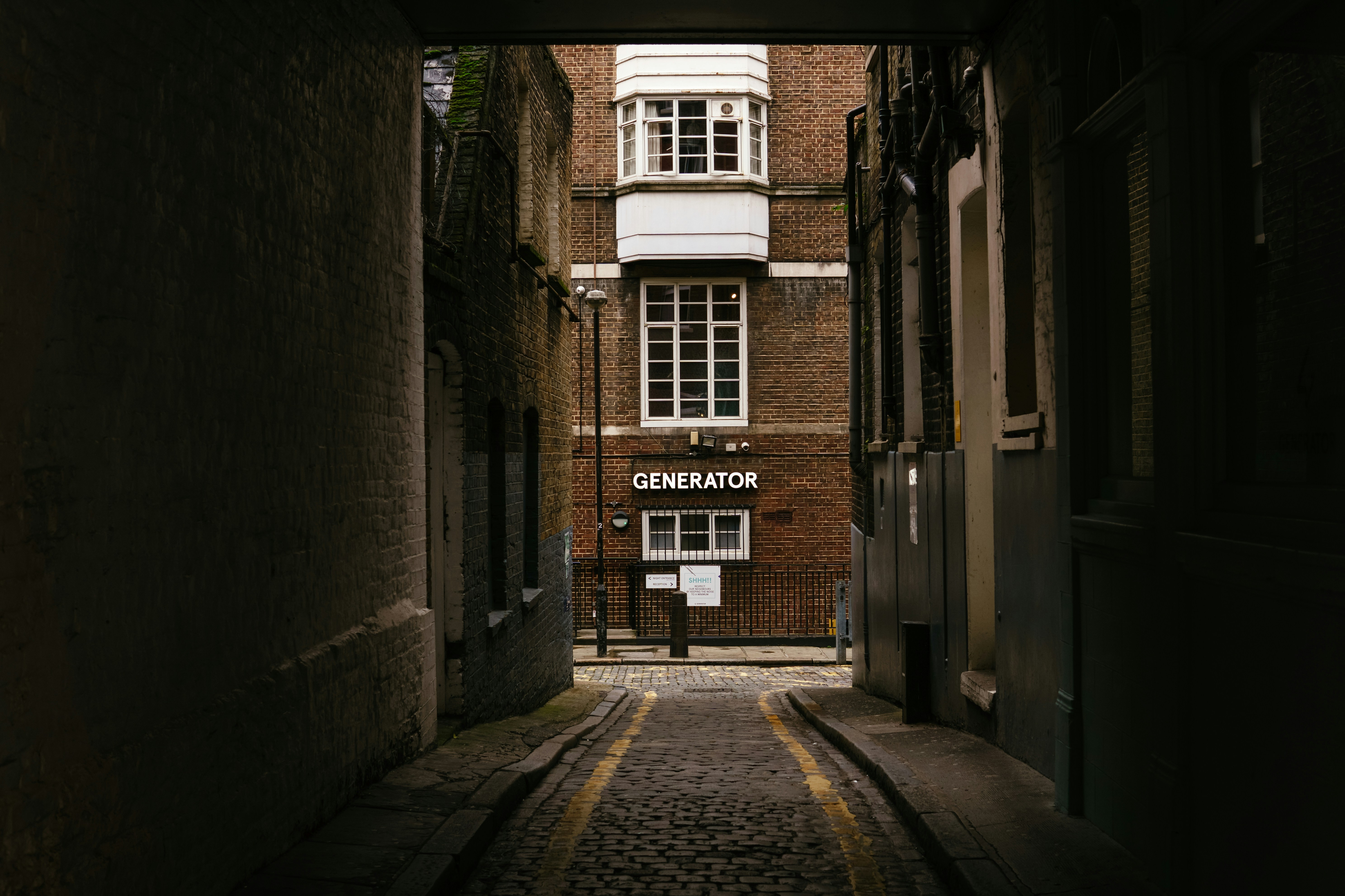 brown brick building with black metal gate