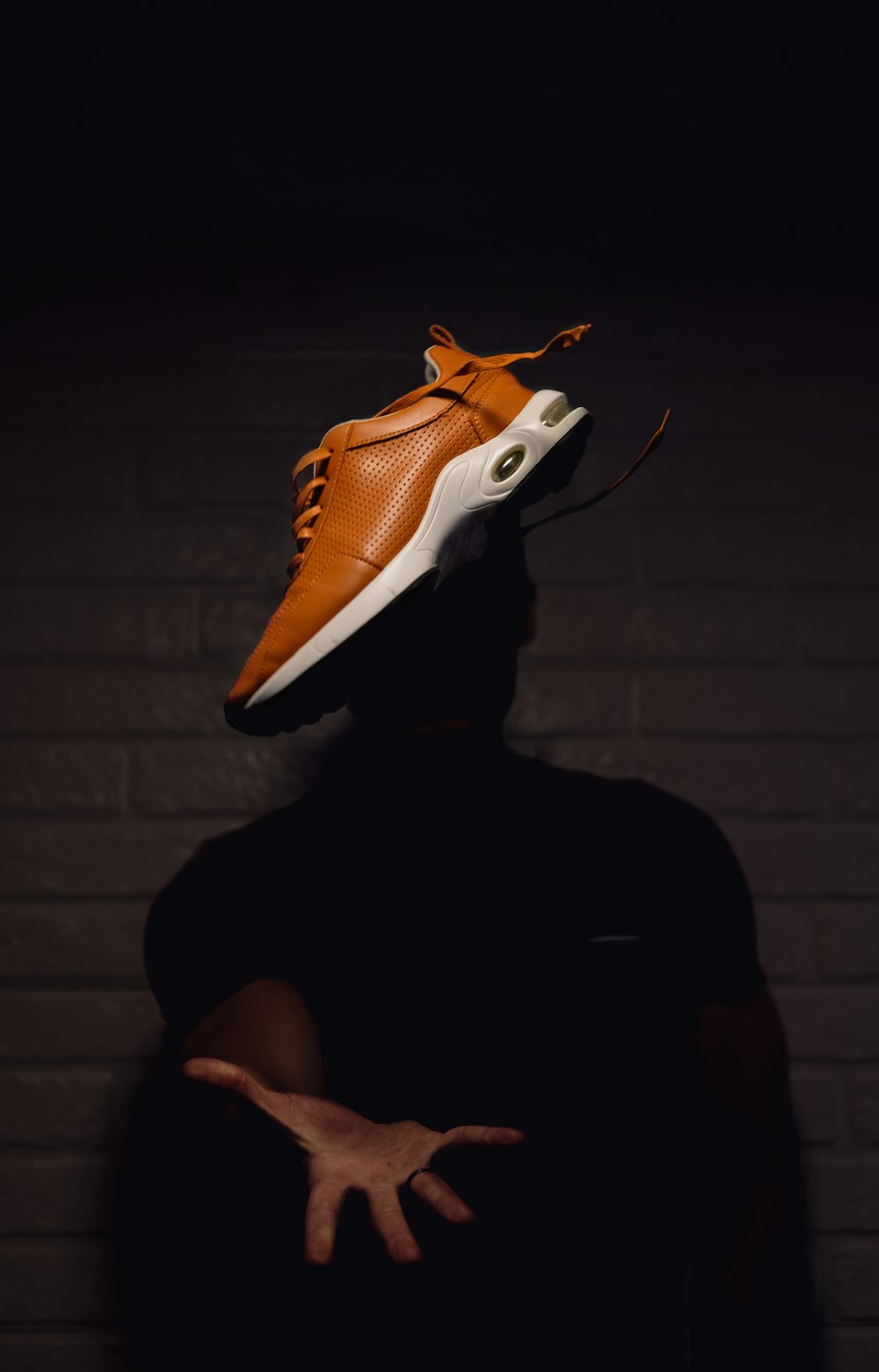 person wearing orange and white nike basketball shoes
