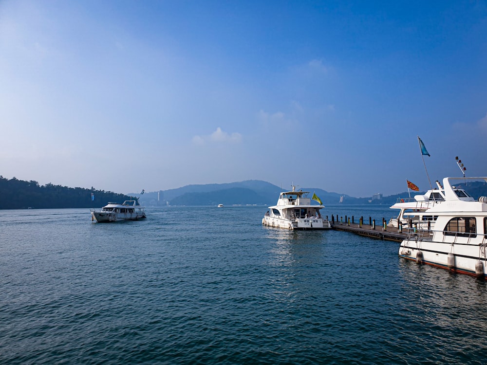 white and brown boat on sea under blue sky during daytime