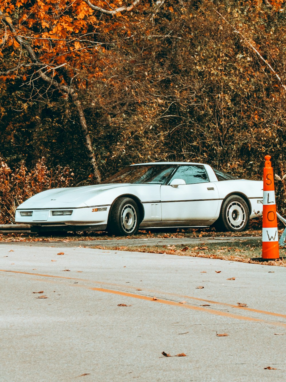 white sedan on road during daytime