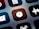 A close-up view of a mobile device screen displaying application icons in a grid layout. Visible icons include a stopwatch, a sound wave, an alarm clock, and other utility symbols. The design is sleek with icons having a minimalist, monochromatic style against a dark background.