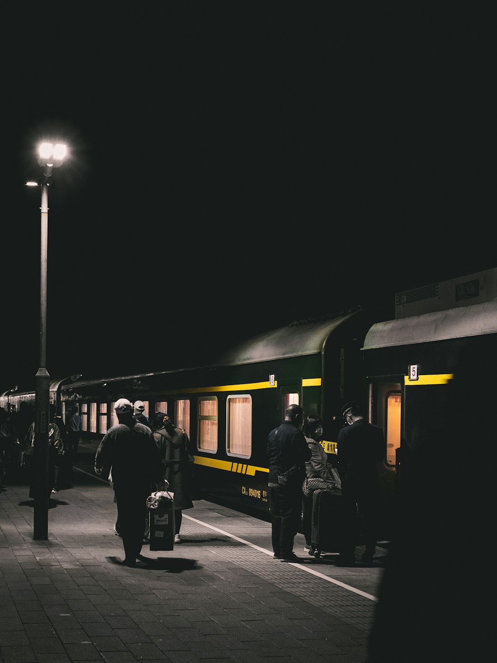 people walking on sidewalk during night time