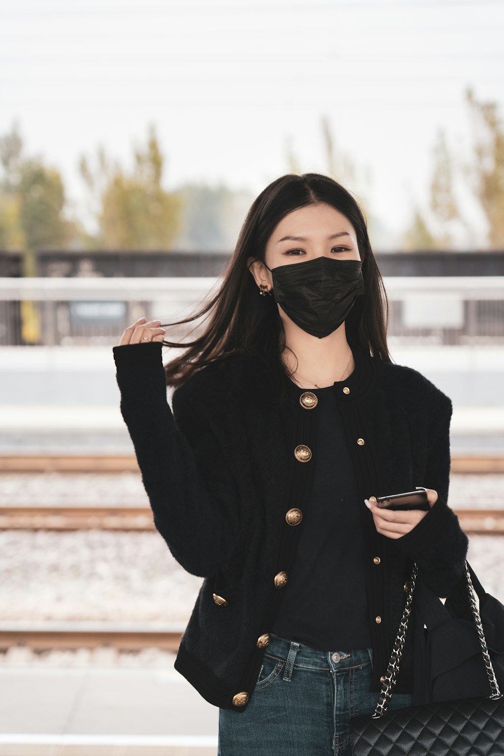 woman in black coat wearing black sunglasses