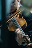 Close-up of a violinist deeply immersed in a classical performance.