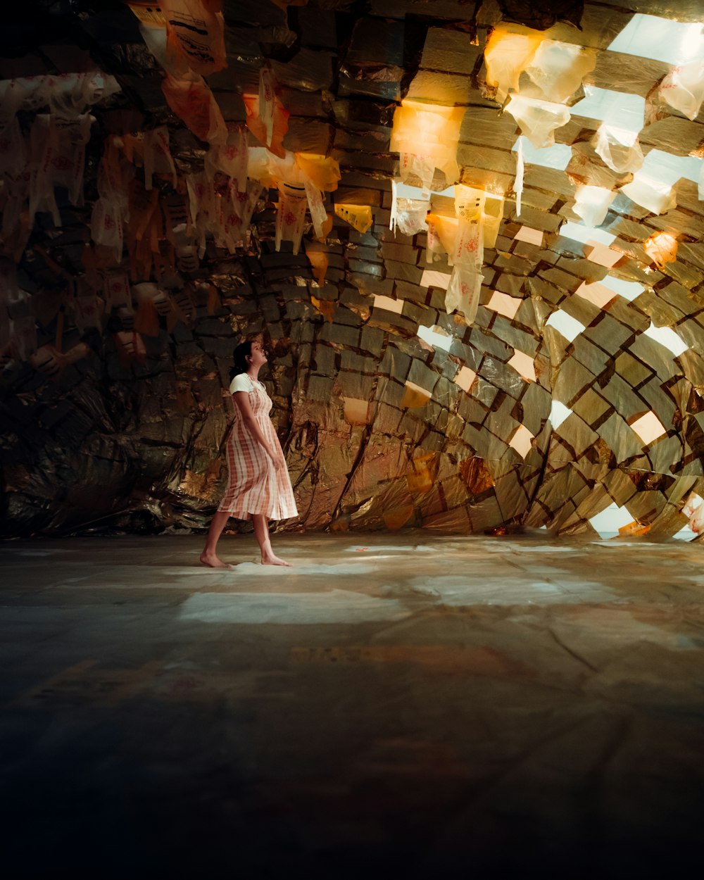 woman in white and pink dress walking on brown wooden pathway