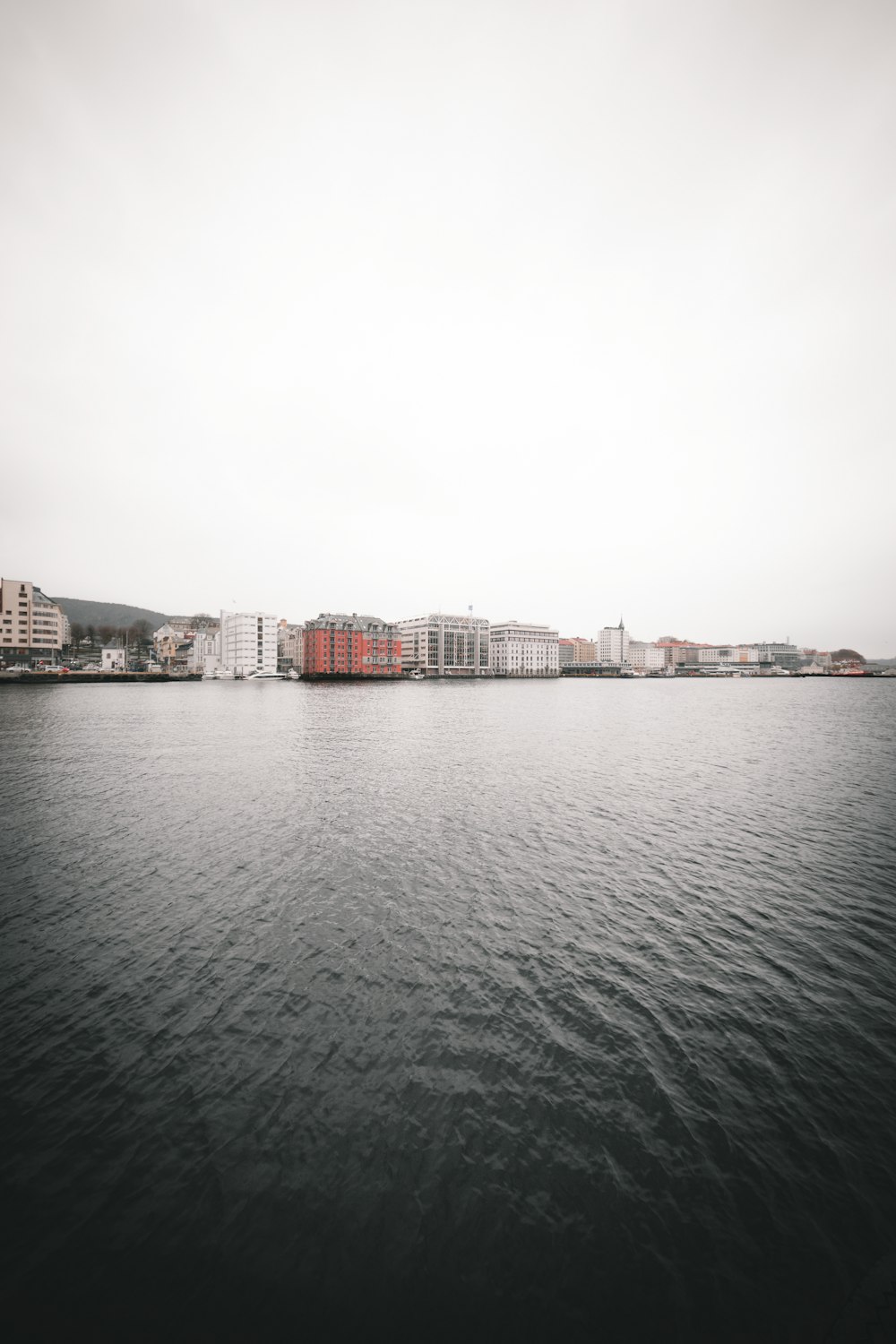 city buildings near body of water during daytime