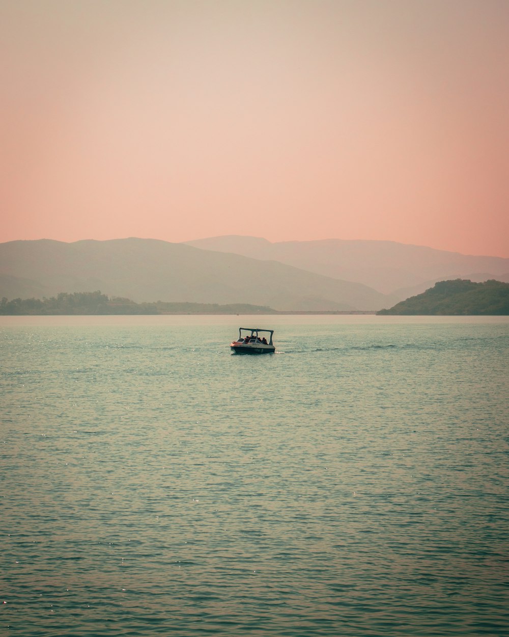 white and black boat on sea during daytime