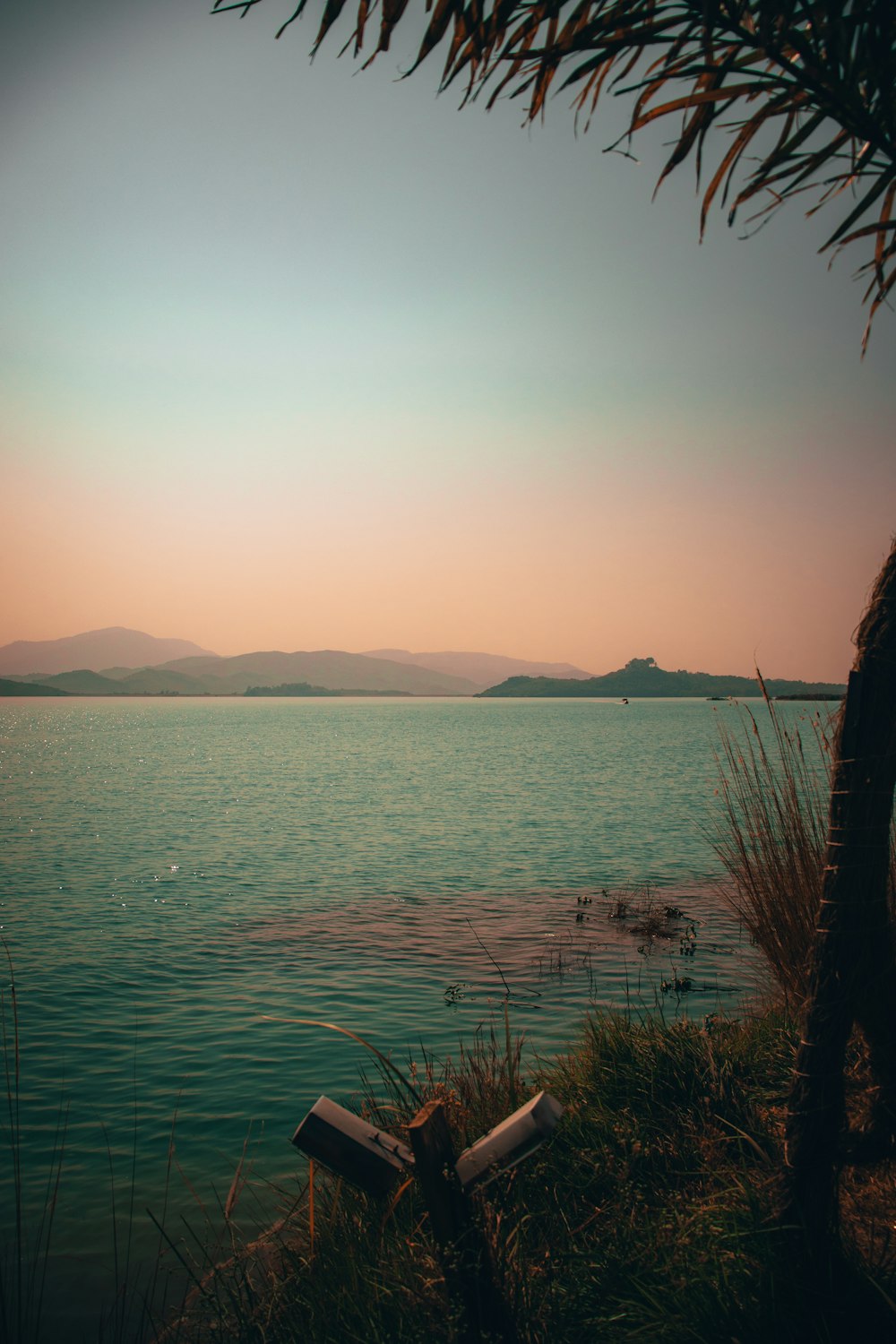 body of water near mountain during daytime