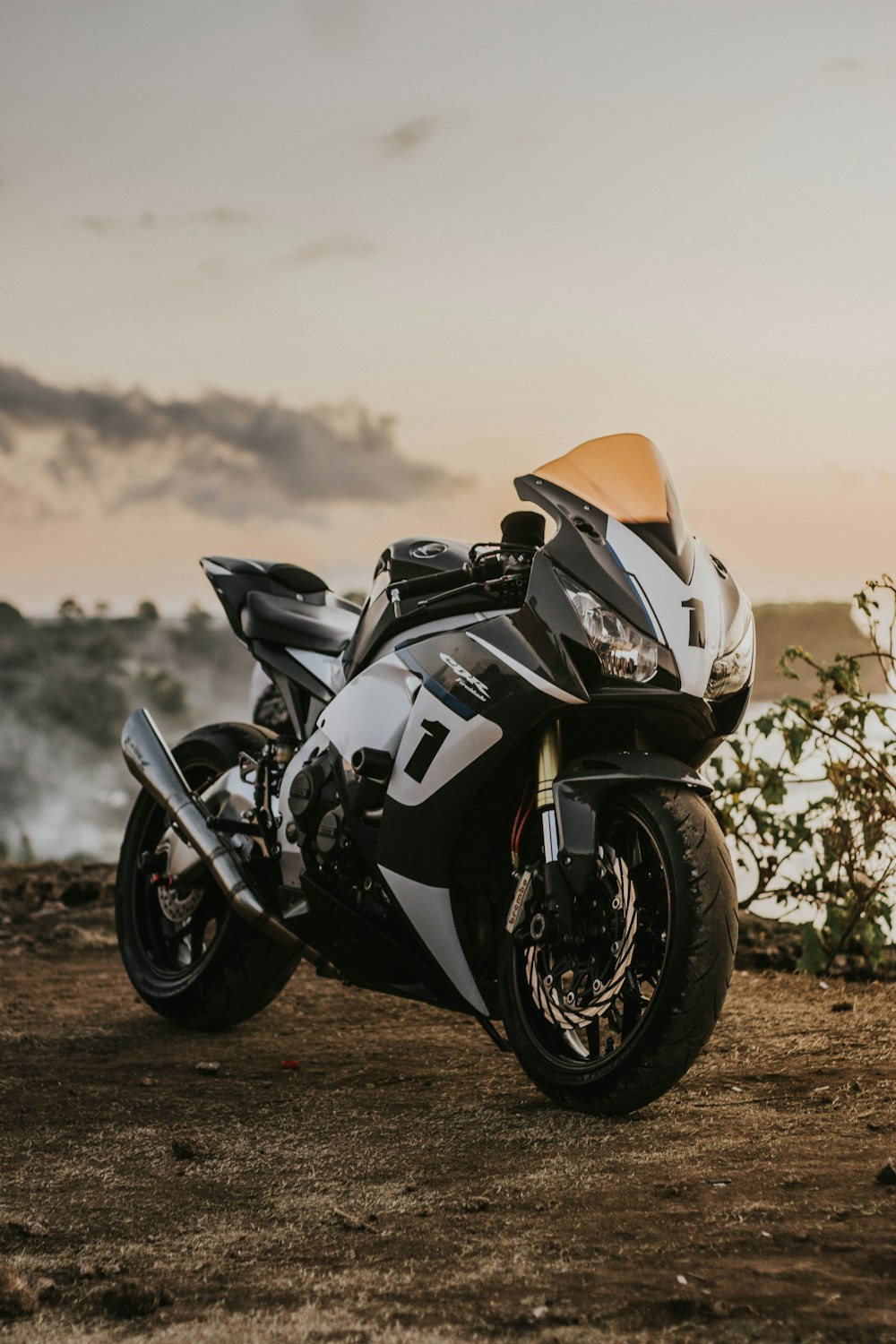 black and orange sports bike on brown field during daytime