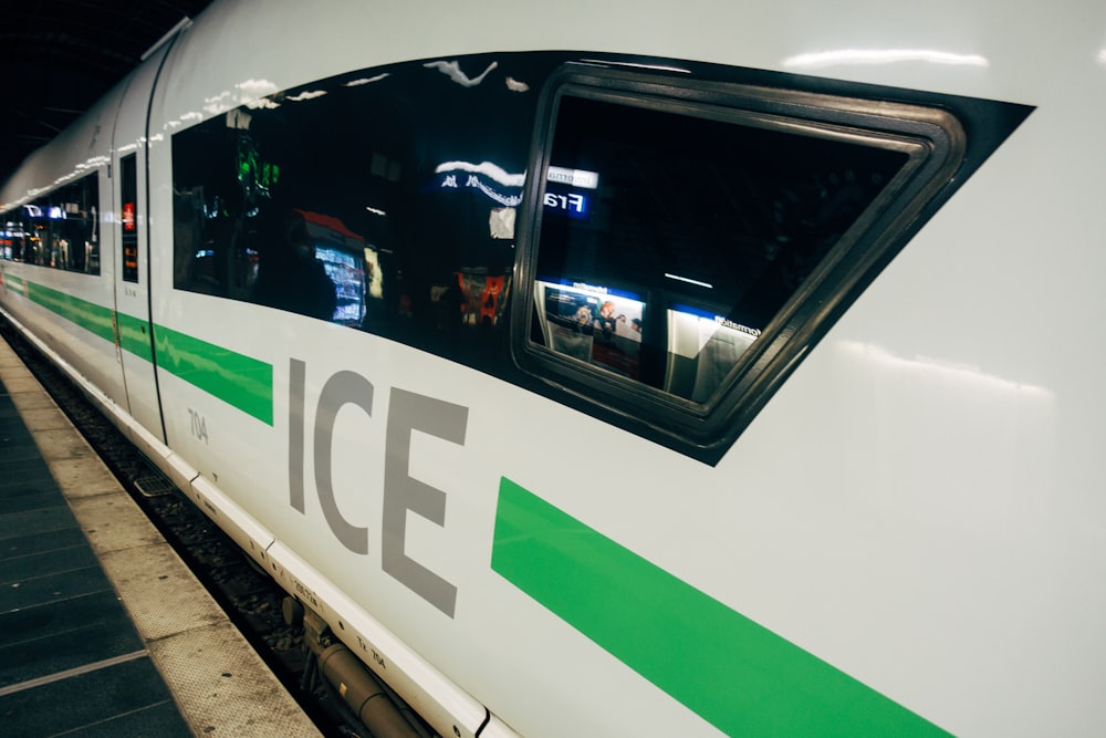 white and green train in train station