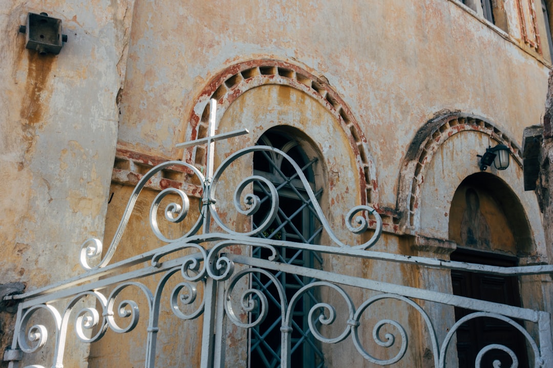 black metal gate on brown concrete building