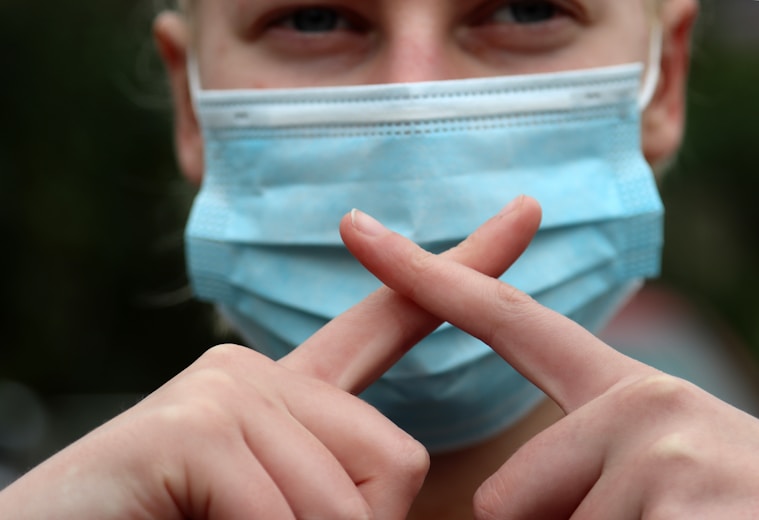 person holding blue and white plastic container