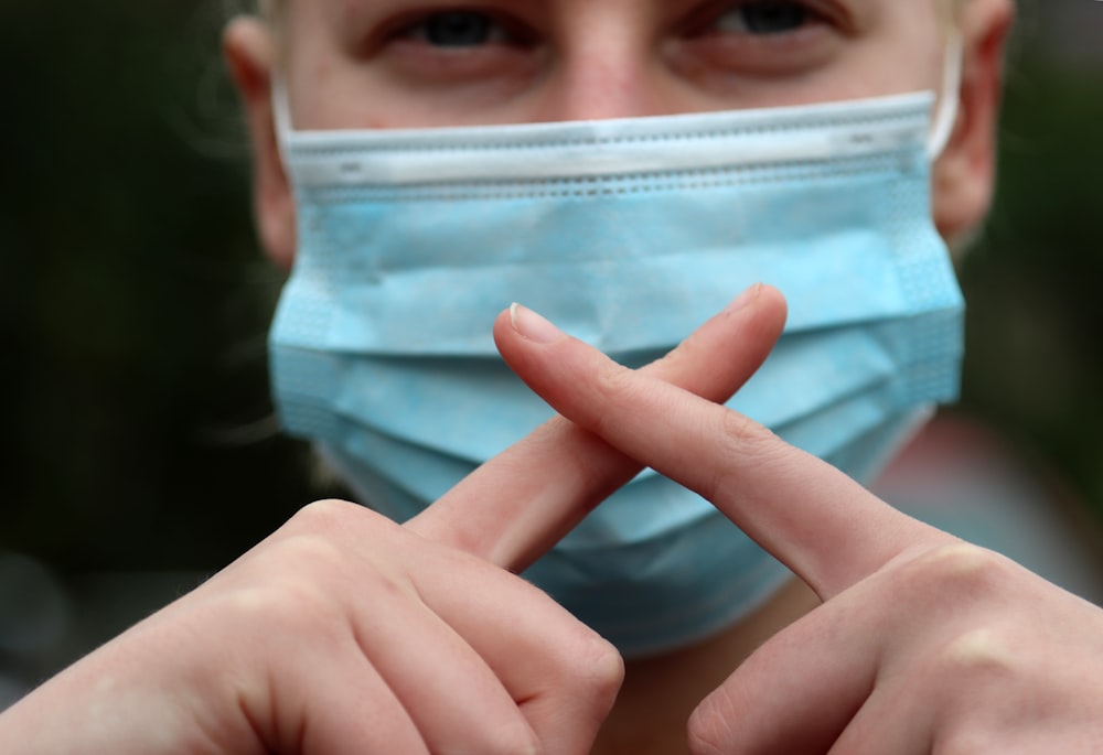 person holding blue and white plastic container