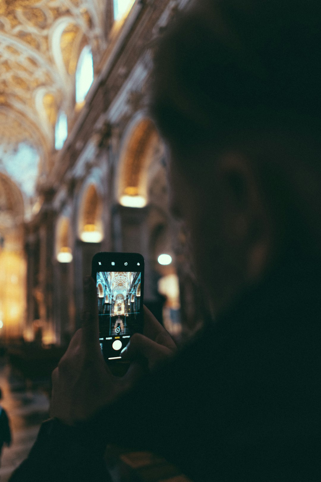 person holding black smartphone taking photo of building