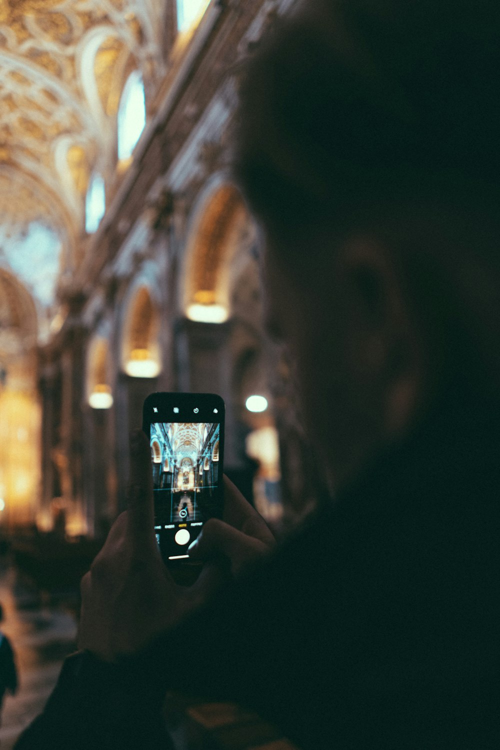 person holding black smartphone taking photo of building