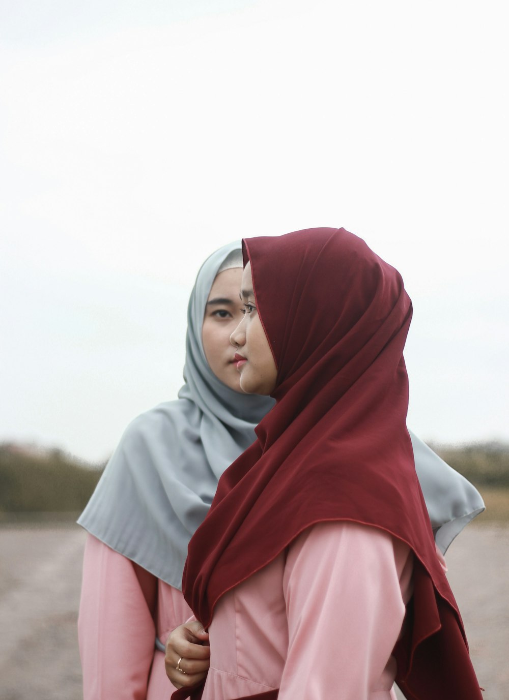 woman in pink hijab standing on field during daytime