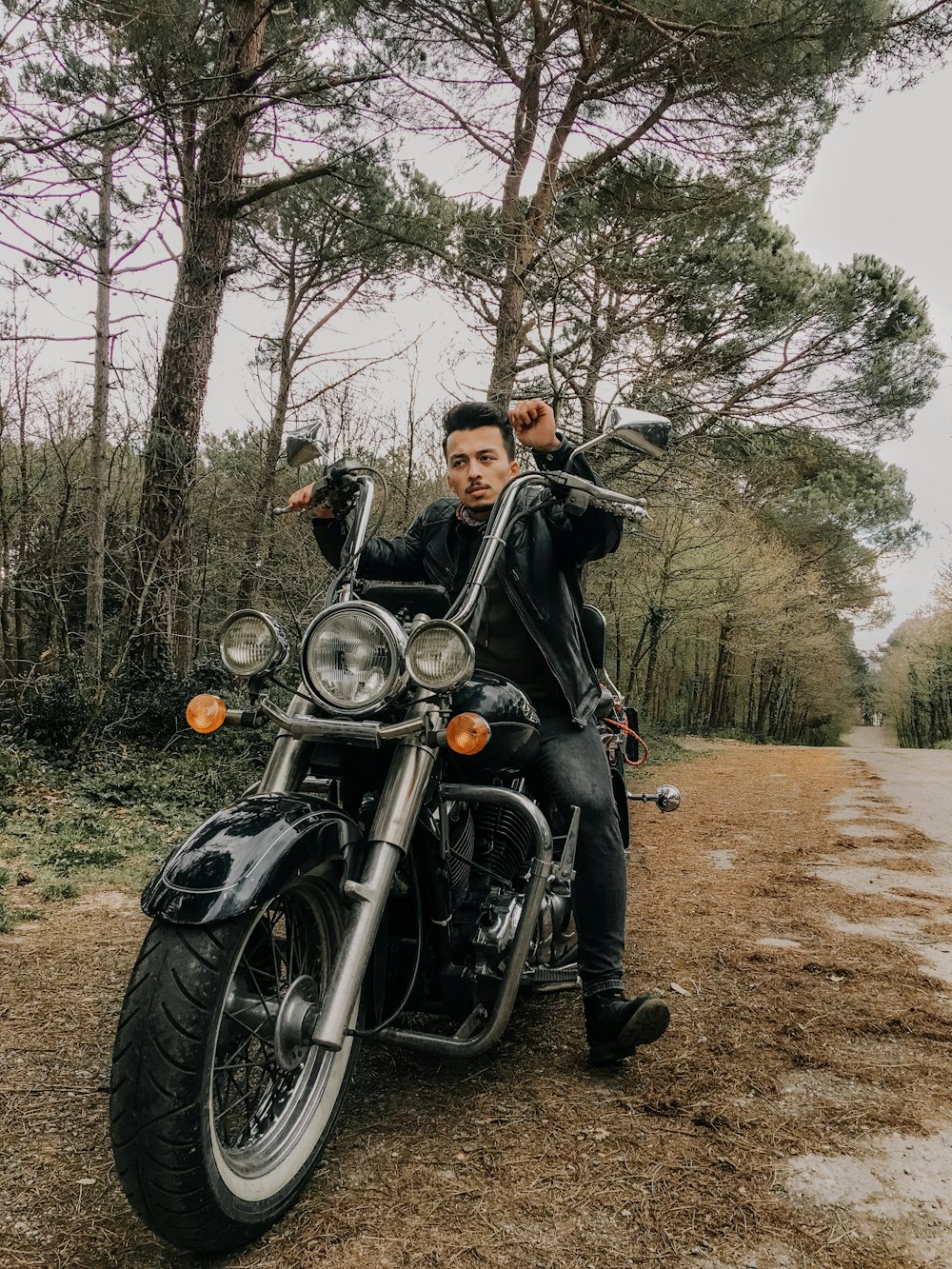 man and woman riding on black cruiser motorcycle during daytime