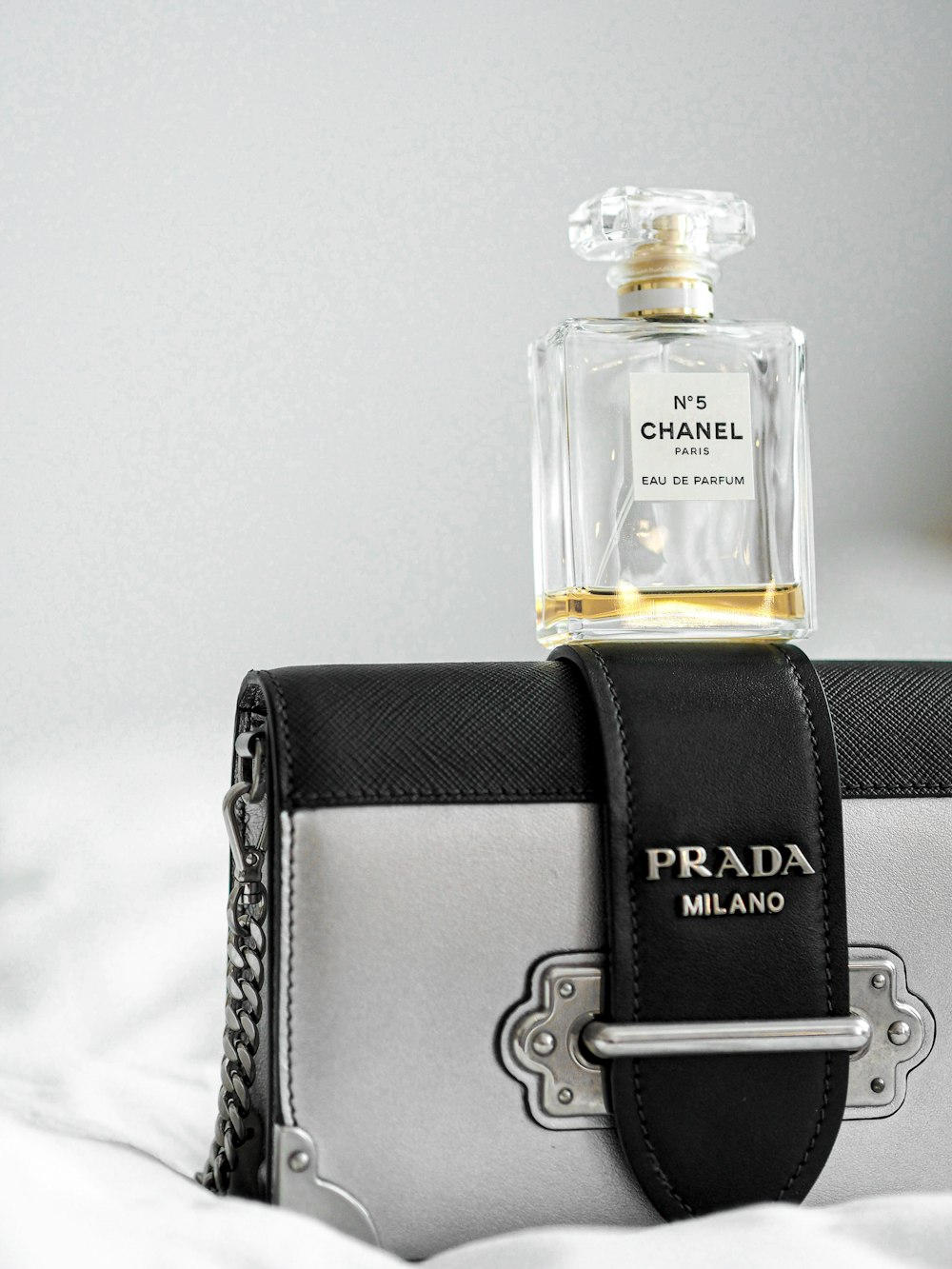 black and gold perfume bottle in black leather bag
