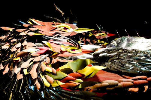 A finished mixed-media piece combining metal, glass, and paint in a harmonious design.