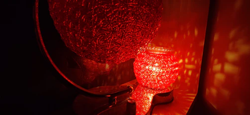 Brightly colored 3D printed lamp casting soft light in a welcoming living room.