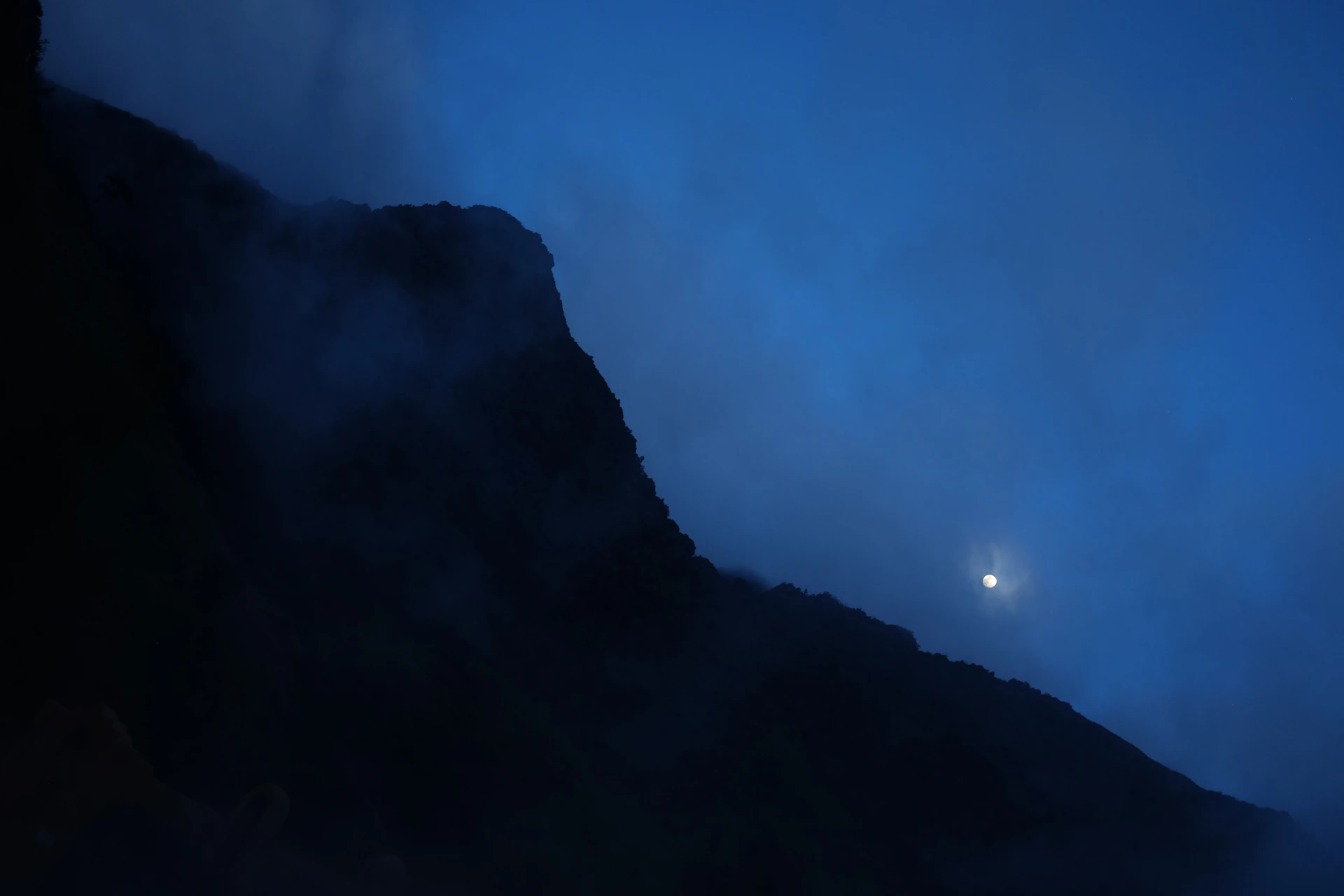 silhouette of mountain under blue sky during daytime