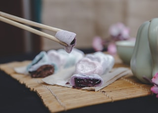 brown wooden chopsticks on brown wooden chopping board