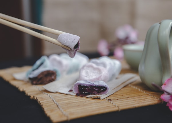 brown wooden chopsticks on brown wooden chopping board