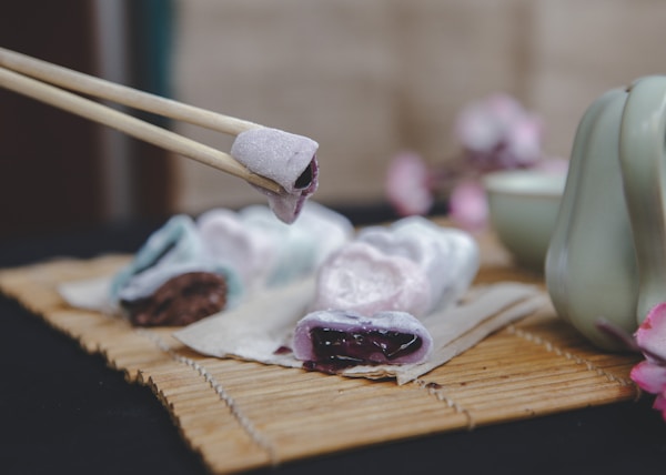 brown wooden chopsticks on brown wooden chopping board