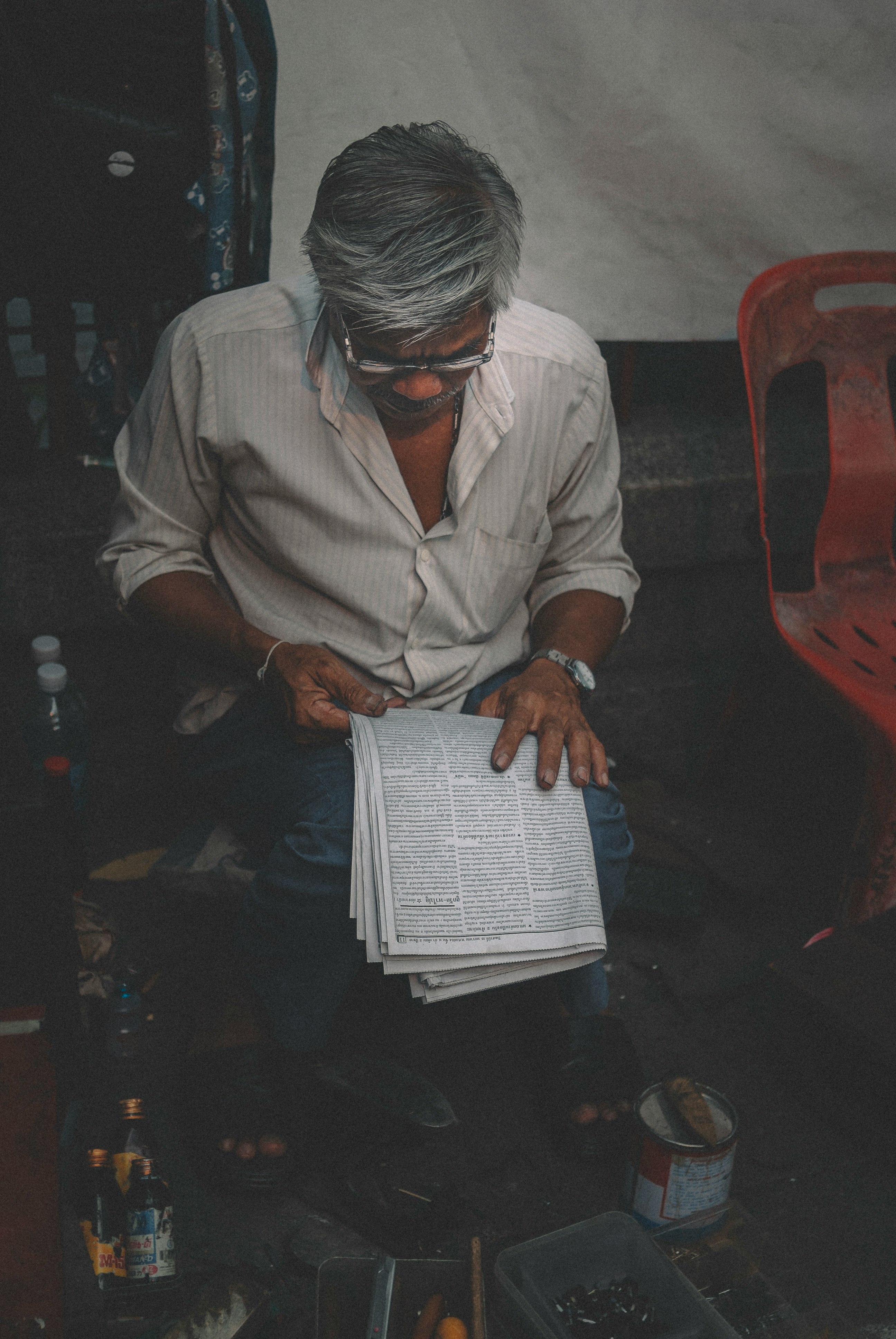 man in white dress shirt reading book