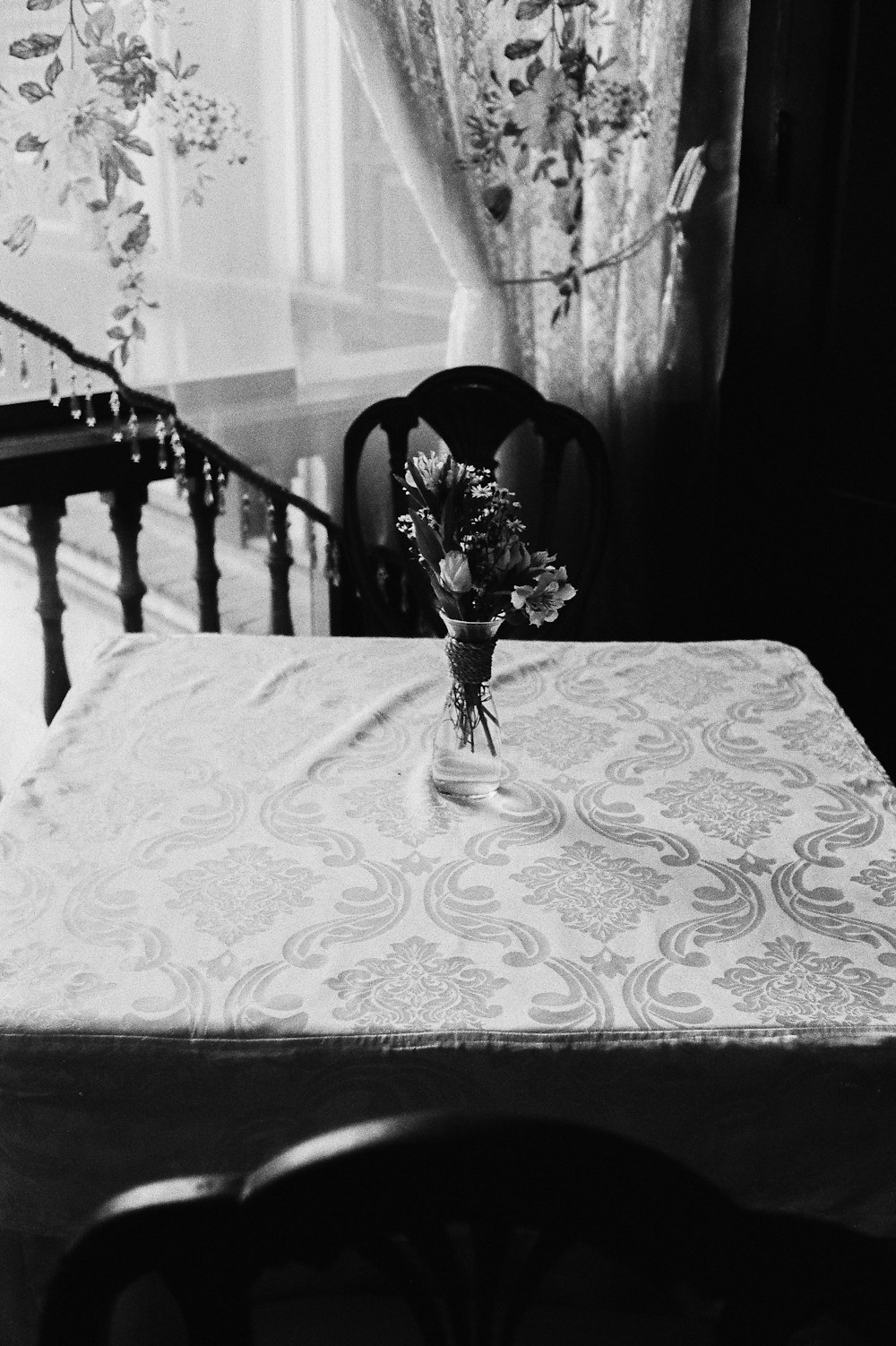 a table with a vase of flowers on top of it