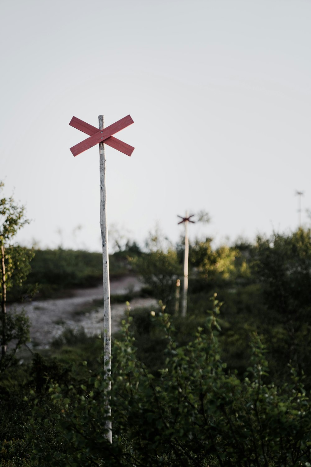 red and white cross on green grass during daytime