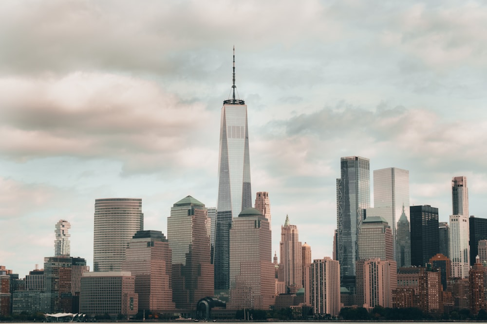 city skyline under white clouds during daytime